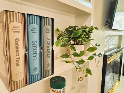 a shelf with books and a potted plant on it at Old Fig House - Historic Fig Garden Neighborhood in Fresno