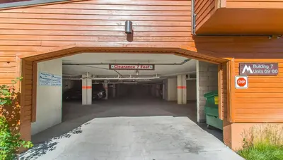 an empty parking garage with a sign in the middle at Corner 3BD with Loft! Walk to Canyon and The Village! in Mammoth Lakes