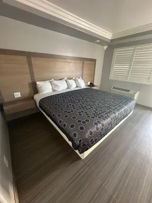 a bedroom with a large bed in a room at HomeTown Inn in Los Banos