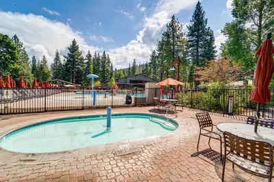 a swimming pool with a table and a playground at Northstar Ski-InandOut Condo with Resort Amenities! in Truckee