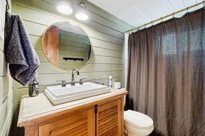 a bathroom with a sink and a mirror at Hot Tub, Game Room and Home Gym Serene Arnold Gem in Arnold