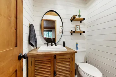 a bathroom with a sink and a mirror at Hot Tub, Game Room and Home Gym Serene Arnold Gem in Arnold