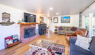 a living room with a couch and a fireplace at Cozy Cabin by Bass Lake, with Boat Slip in Bass Lake