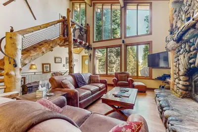 a living room with leather furniture and a fireplace at Tahoe Timber Retreat in Carnelian Bay