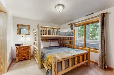 a bedroom with two bunk beds and a window at Tahoe Timber Retreat in Carnelian Bay