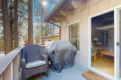 a porch with a wicker chair on a deck at Sierra Snow Haven in Incline Village