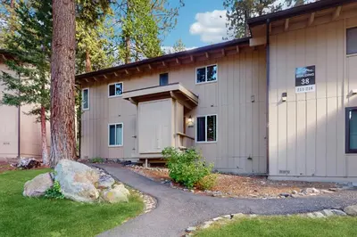 a large building with a tree and a driveway at Sierra Snow Haven in Incline Village