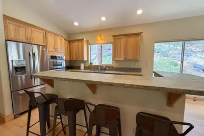 a kitchen with a large island with bar stools at Tahoe Boulders in South Lake Tahoe