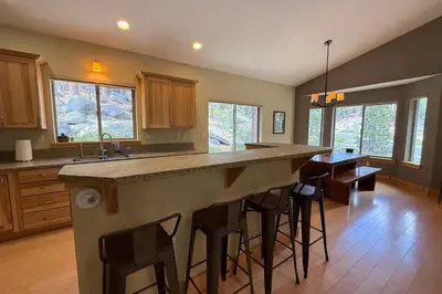 a kitchen with a large island with bar stools at Tahoe Boulders in South Lake Tahoe