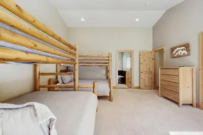 a bedroom with two bunk beds and a dresser at Tahoe Boulders in South Lake Tahoe