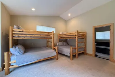 a bedroom with two bunk beds and a window at Tahoe Boulders in South Lake Tahoe