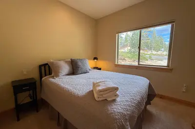 a bedroom with a bed with a blanket on it at Tahoe Boulders in South Lake Tahoe