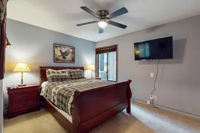 a bedroom with a bed and a ceiling fan at Fireside 106 in Mammoth Lakes