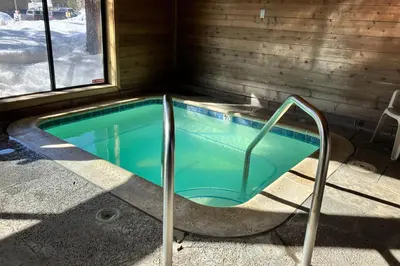 a jacuzzi tub in a cabin with a window at Fireside 106 in Mammoth Lakes