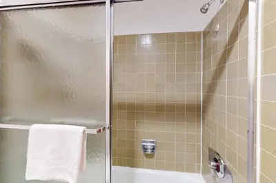 a bathroom with a shower with a glass door at Val D'Isere 30 in Mammoth Lakes