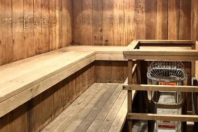 a wooden sauna with a bench and a fan at Sunshine Village 169 in Mammoth Lakes