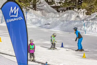 a group of three people skiing in the snow at Val D'Isere 16 in Mammoth Lakes