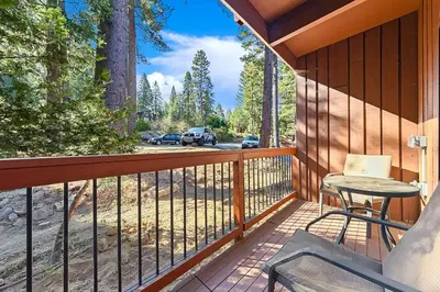 a balcony with a table and chairs on a porch at Yosemite West Condo B104 in Yosemite West