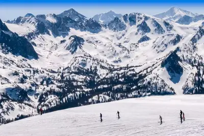 a group of people skiing down a snow covered mountain at Fireside 111 in Mammoth Lakes