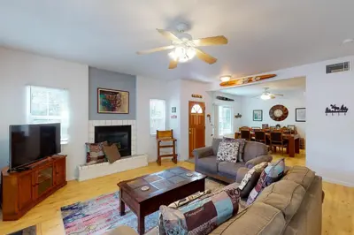 a living room with a couch and a flat screen tv at Moler Lake House in Bass Lake