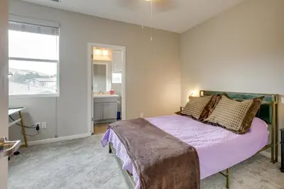 a bedroom with a bed with purple sheets and a window at Home Base with Easy 1-80 Access 4 Mi to Dtwn Reno! in Reno