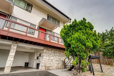 a tree in front of a building with a balcony at 2 Mi to Dtwn Reno and UNR City-View Townhome! in Reno
