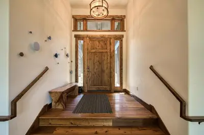 a hallway with stairs leading to a wooden door at Rising Sun Retreat at Schaffer's Mill by Tahoe Getaways - Luxury Pet Friendly w Air Conditioning in Truckee