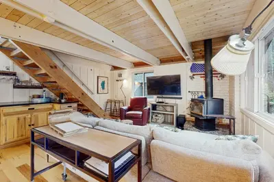 a living room with a couch and a table at Camp Tahoe in Incline Village