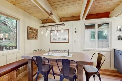 a dining room with a wooden table and chairs at Camp Tahoe in Incline Village