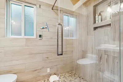 a bathroom with a shower and a toilet and a sink at Camp Tahoe in Incline Village