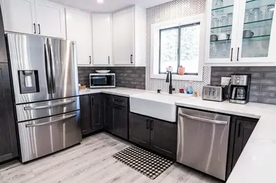 a kitchen with white cabinets and stainless steel appliances at Mammoth Lakes Ski Getaway in Mammoth Lakes