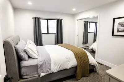 a bedroom with a bed and a couch and windows at Mammoth Lakes Ski Getaway in Mammoth Lakes