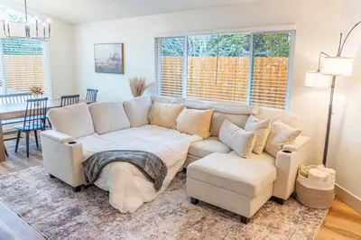 a living room with a white couch and a chair at Modern Western Retreat Pet Friendly 4 Bed 2 Bath in Reno