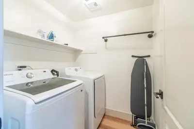 a small laundry room with a washer and dryer at Modern Western Retreat Pet Friendly 4 Bed 2 Bath in Reno