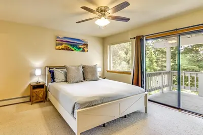 a bedroom with a bed and a ceiling fan at 3 Mi to Lake Tahoe Forest-View Sanctuary with Deck! in Incline Village