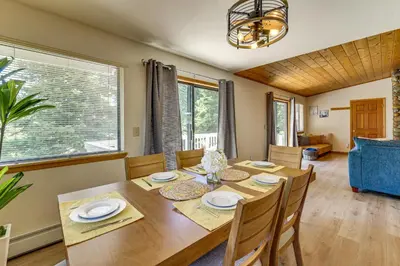 a dining room with a wooden table and chairs at 3 Mi to Lake Tahoe Forest-View Sanctuary with Deck! in Incline Village