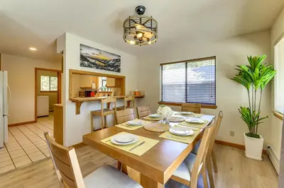 a dining room and kitchen with a table and chairs at 3 Mi to Lake Tahoe Forest-View Sanctuary with Deck! in Incline Village