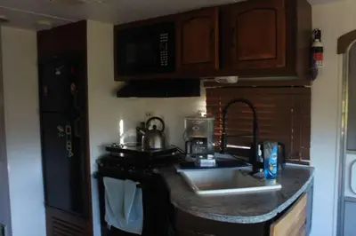 a kitchen with a sink and a counter top at Comfortable Guest RV With EV charger Semi Rural Area in Bodfish