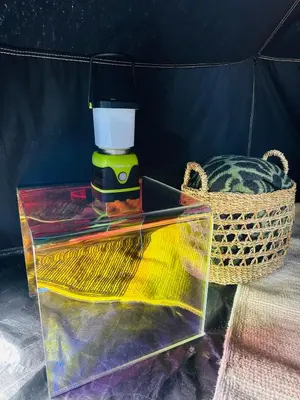 a glass table with a lamp and a basket at Rocky Ridge Glamping Yosemite in Coarsegold
