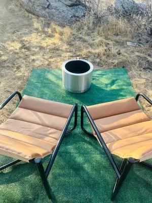 two chairs and a fire pit on the grass at Rocky Ridge Glamping Yosemite in Coarsegold