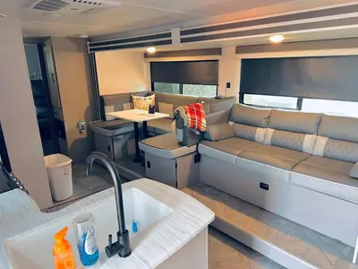 a kitchen and living room with a couch and a sink at DDs Country Camper in Reedley