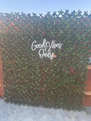 a hedge with a sign that reads good vibes only at DDs Country Camper in Reedley