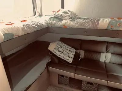 a small room with a couch and a bed at DDs Country Camper in Reedley