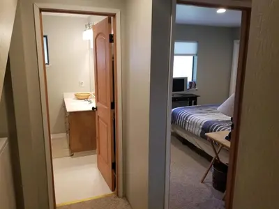 a bedroom with a bed and a door leading to a bathroom at Kirkwood On Meadow 3br 1 ba in Kirkwood