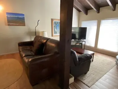 a living room with a leather couch and a television at Lake Village Resort 3 bedroom condo in Zephyr Cove
