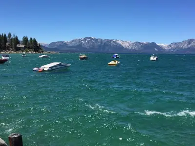 a group of boats in a large body of water at Lake Village Resort 3 bedroom condo in Zephyr Cove