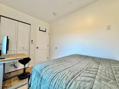 a bedroom with a bed and a desk with a computer at Unique Container, Home 20 Acres, Modern Stay in Placerville