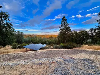 a house with a solar panel in a field at Unique Container, Home 20 Acres, Modern Stay in Placerville