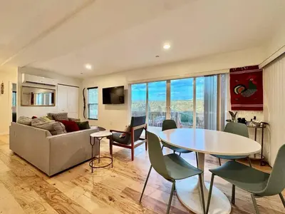a living room with a table and a couch at Unique Container, Home 20 Acres, Modern Stay in Placerville