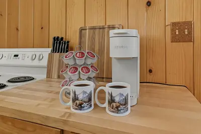 a kitchen with two cups of coffee on a counter at Dogwood Star Star Location Cozy Vibes in Shaver Lake